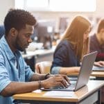 Tips for Improving Ransomware Protection for Schools 1 Students working at laptop computers to show the need for ransomware protection in schools.